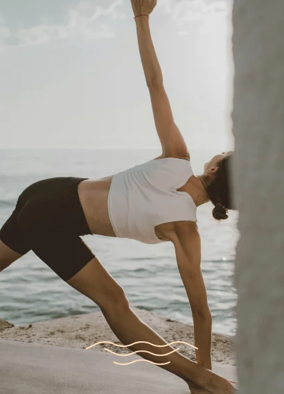 Woman practicing yoga on the beach in Torrevieja, Costa Blanca